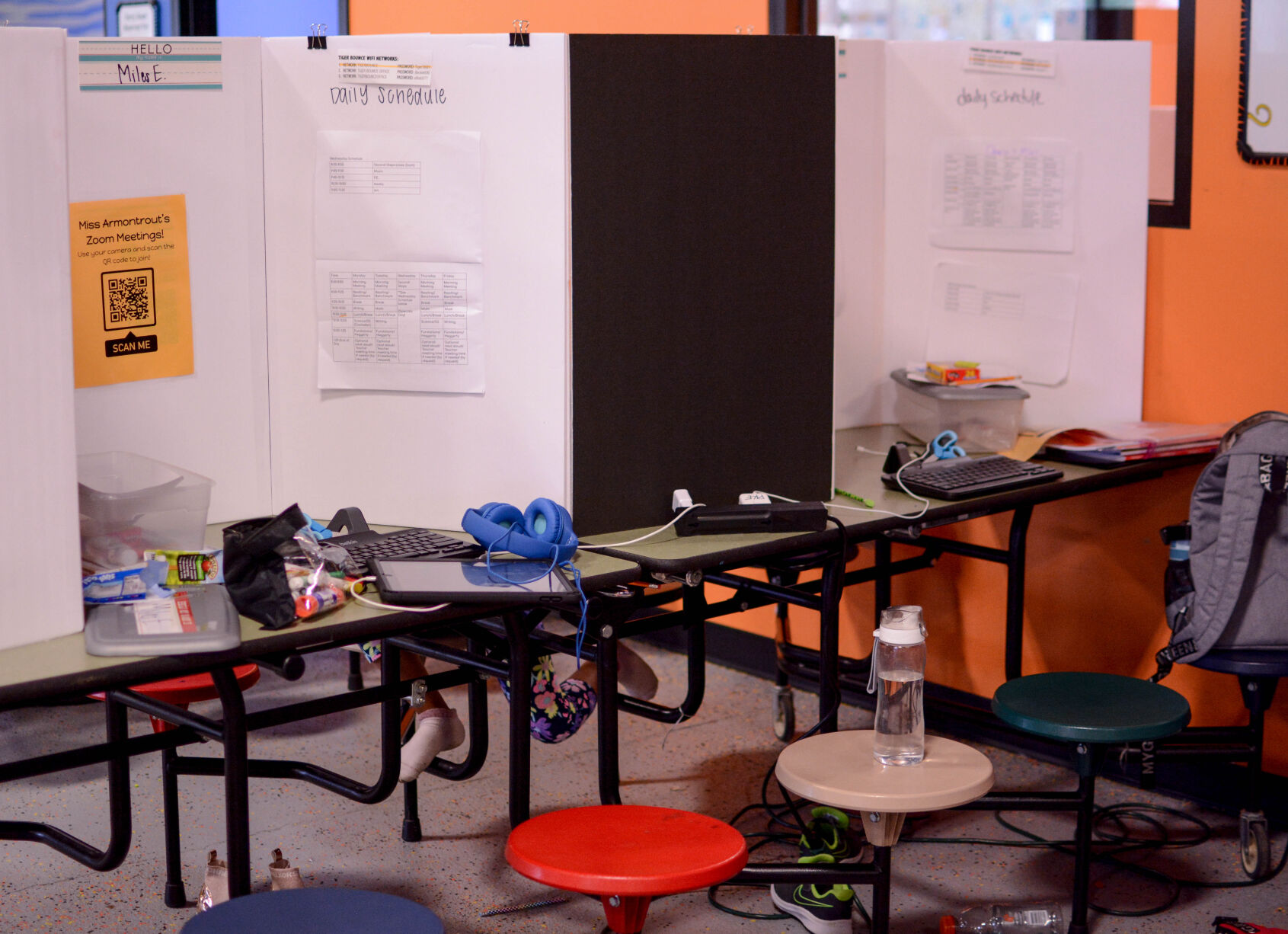 The personal belongings of two students scatter across their desks
